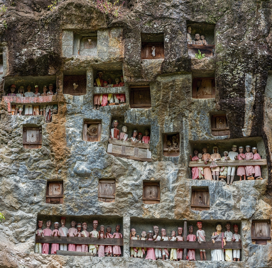 Rock tombs and galleries of Tau Tau in the steep rock face of the burial site of Lemo in Tana Toraja on Sulawesi. The Tau Tau symbolize the continuation of the life of the deceased in the afterlife.